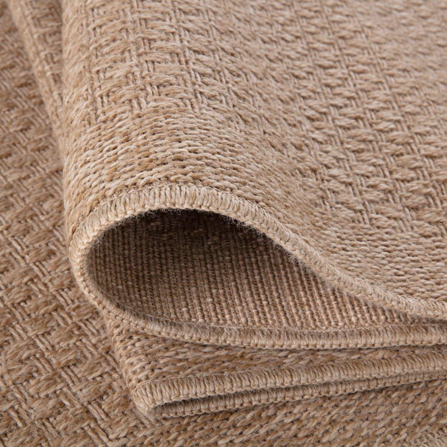 Beige woven nature outdoor rug with textured herringbone pattern made from natural fibers outdoor rug neutral