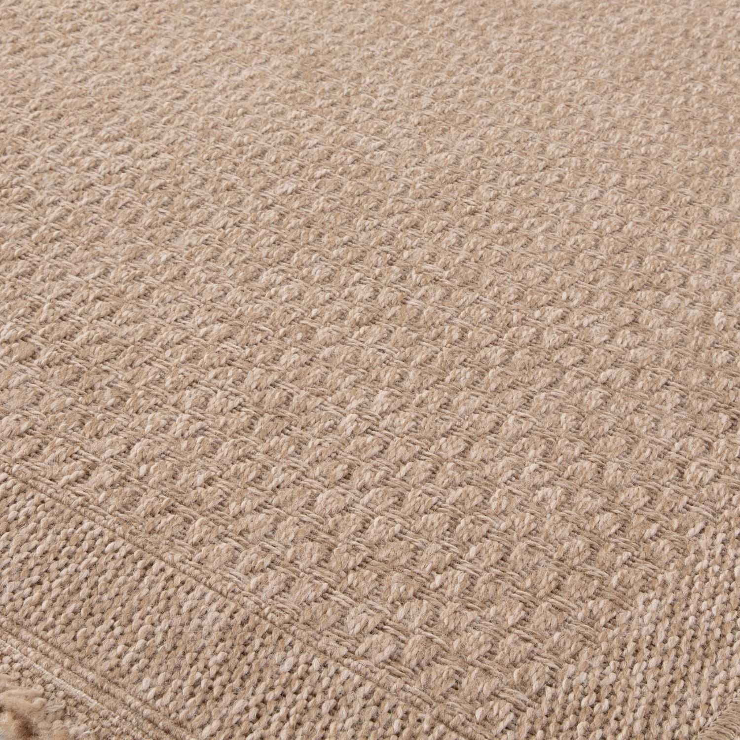 Beige woven nature outdoor rug with textured interlaced pattern and fringed edges perfect outdoor rug neutral option