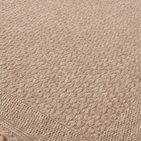 Beige woven nature outdoor rug with textured interlaced pattern and fringed edges perfect outdoor rug neutral option