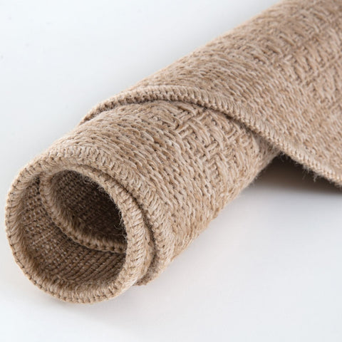 A rolled beige burlap nature outdoor rug with a coarse woven texture perfect as an outdoor rug neutral option