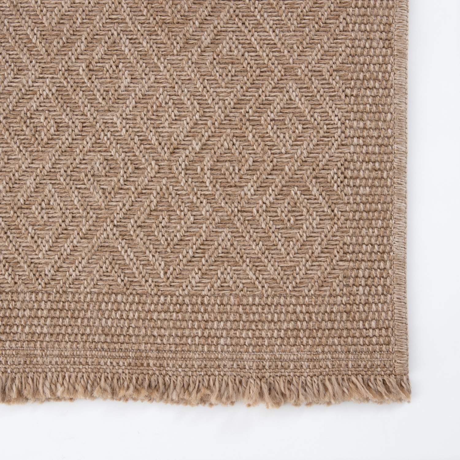 Beige woven nature outdoor rug with diamond pattern and fringed edges perfect as an outdoor rug neutral option