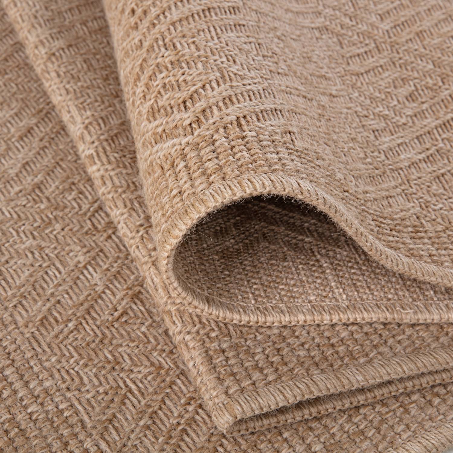 Beige woven nature outdoor rug with textured herringbone pattern perfect as an outdoor rug neutral option