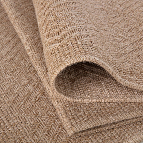 Beige woven nature outdoor rug with textured herringbone pattern perfect as an outdoor rug neutral option