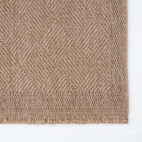 Beige woven nature outdoor rug with herringbone pattern and fringed edges perfect outdoor rug neutral choice