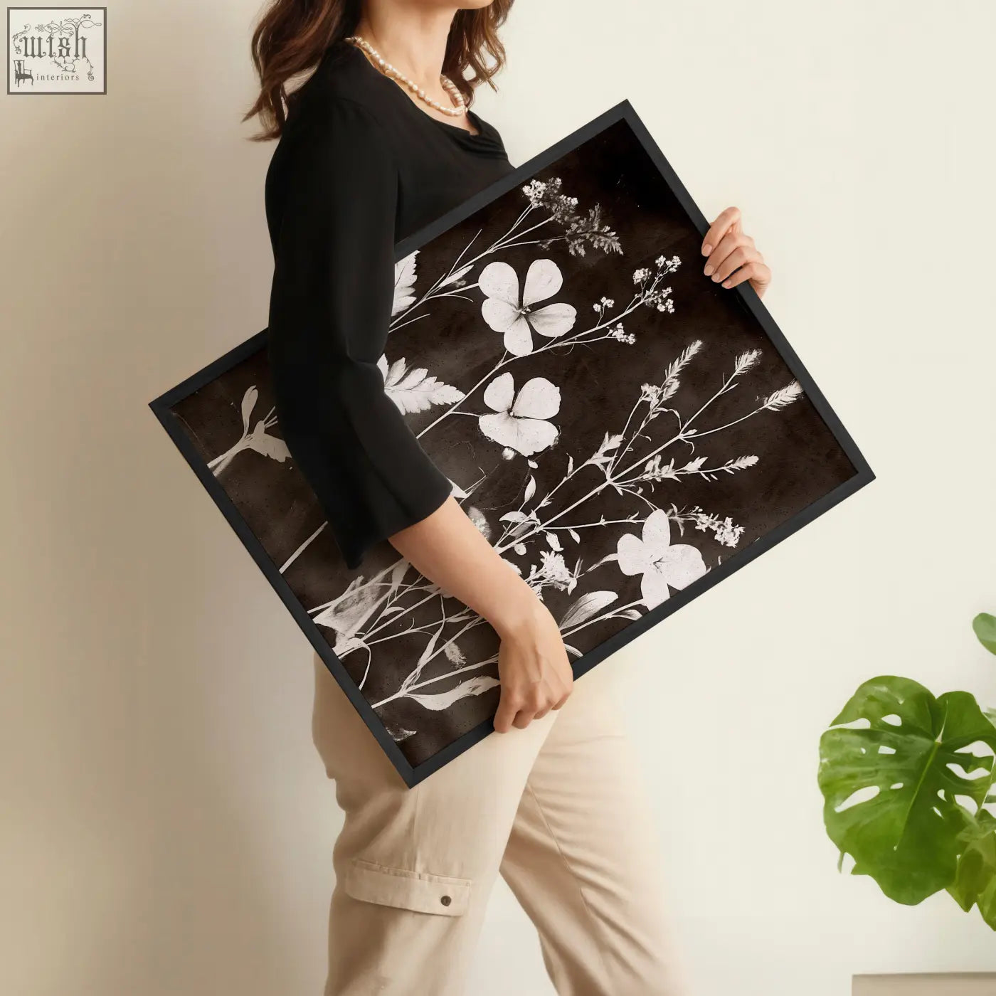 Black-framed nature painting art print of delicate white wildflowers and leaves on a dark brown-black background