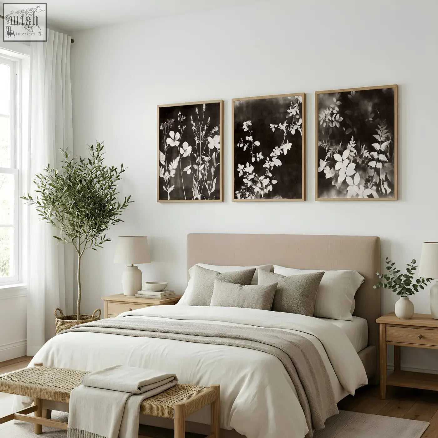 Beige upholstered bed with matching pillows and neutral throw blanket below dark brown black nature painting art prints set of 3