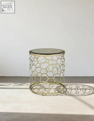 Nested glass side table with gold-toned honeycomb metal frame and clear glass top perfect for modern spaces