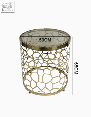 Gold-toned nested glass side table with geometric lattice design and clear glass top perfect for modern living spaces