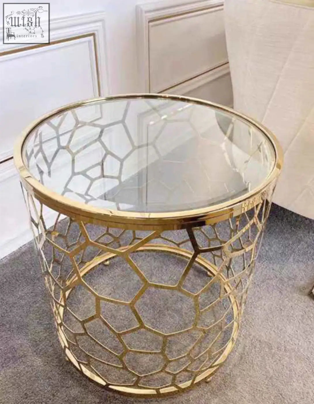 Gold-toned nested glass side table with geometric metal frame and clear glass top perfect for modern spaces
