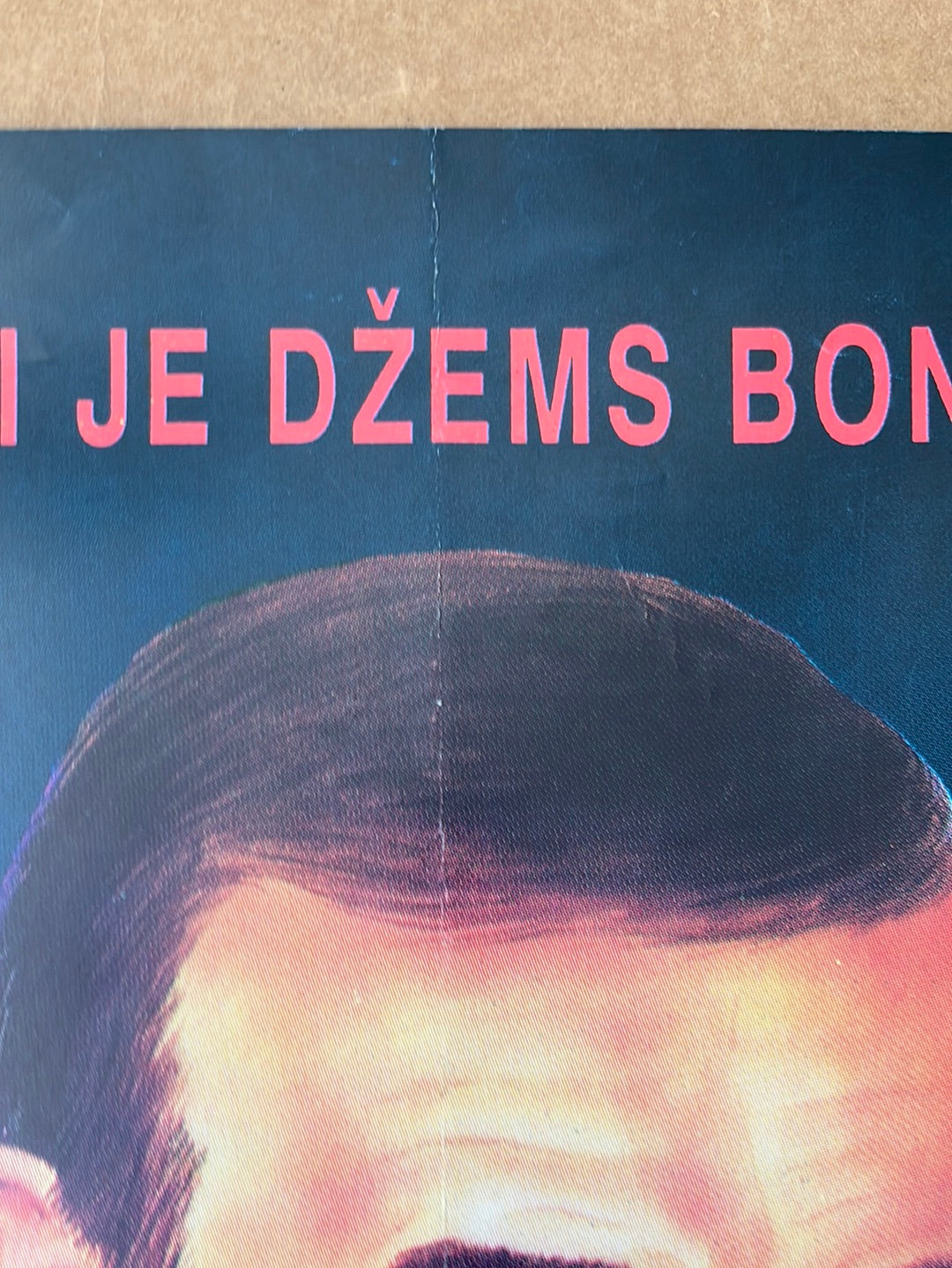 A close-up of the original yugoslavian never say never again 1983 cinema poster showing a man with dark hair