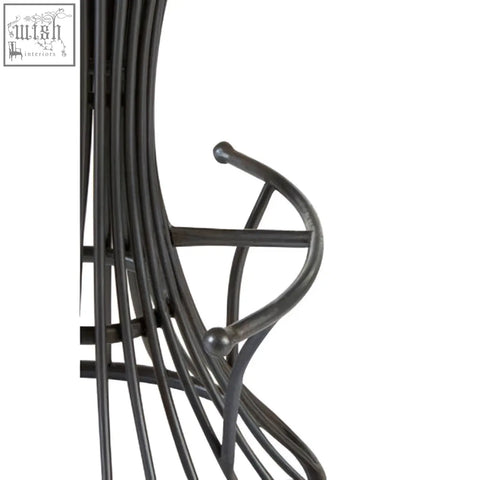Black wrought iron metal bar stool with curved armrests and spherical finials paired with elm wood seat