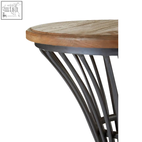 Round wooden tabletop with dark elm wood finish and slender black metal legs on new foundry metal bar stool