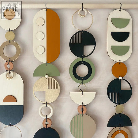 Modern wall art featuring layered wooden plaques in earthy tones like orange olive green black and cream for home decor