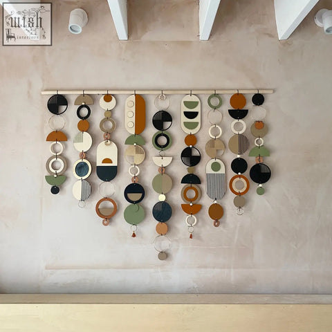A modern wall art featuring layered geometric shapes in terracotta olive green black and cream perfect for minimal home decor