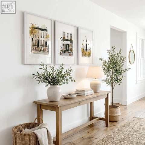 A white ceramic vase with eucalyptus branches complements ochre new york travel wall art set of 3 prints