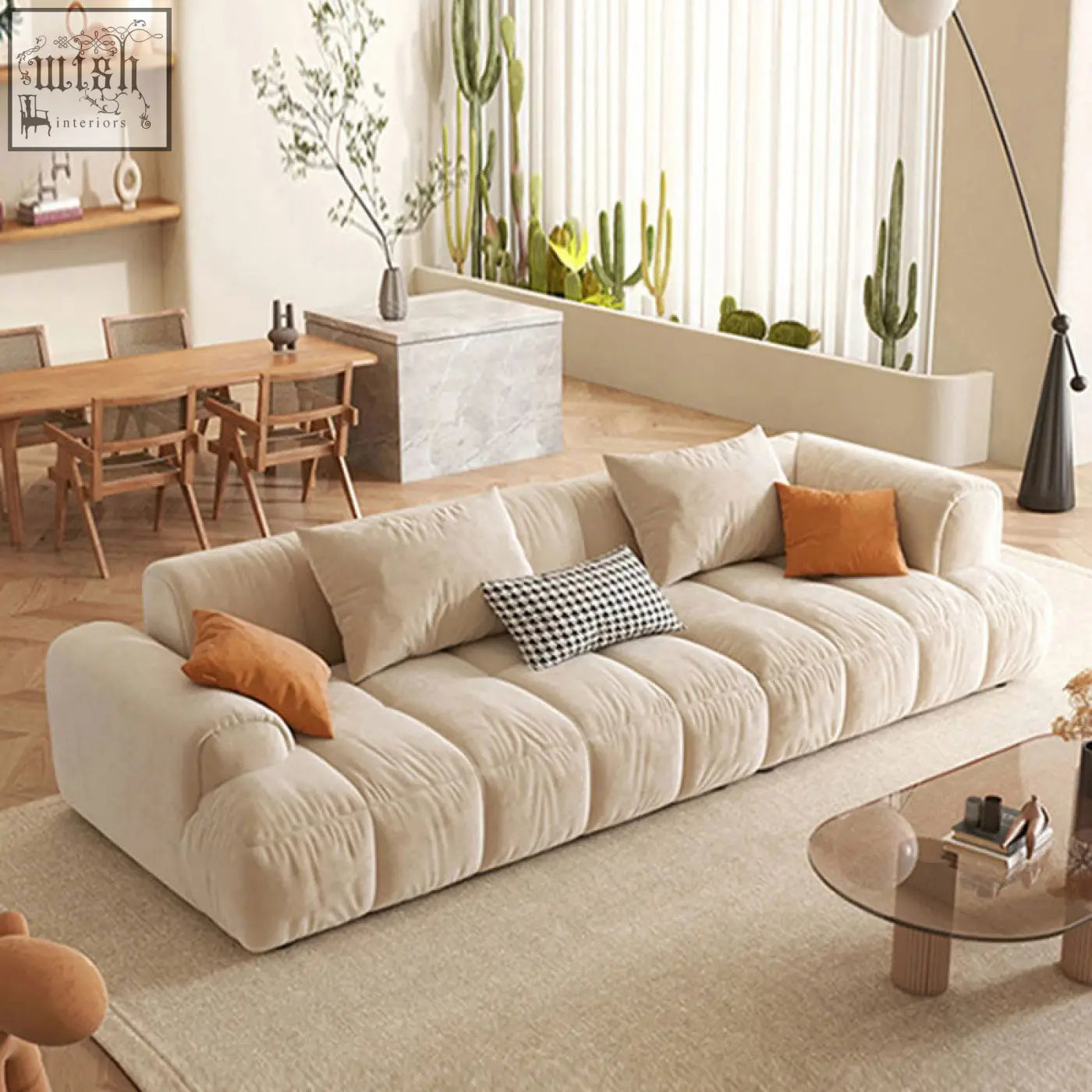 Cream-colored plush velvet sectional newbury modern three seater sofa with tufted segments and accent pillows