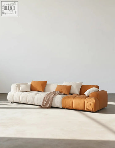 Newbury modern three seater sofa with plush segmented design in cream and burnt orange velvet upholstery