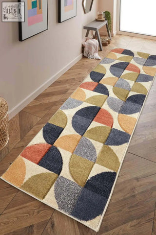 A long cream-colored newport geometric rug with bold overlapping navy, mustard, terracotta, and gray semi-circles pattern