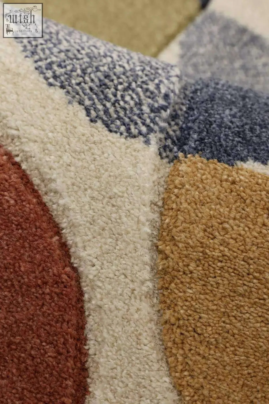 A plush newport geometric rug with a bold multicolour geometric pattern in beige rust red mustard yellow and muted blue