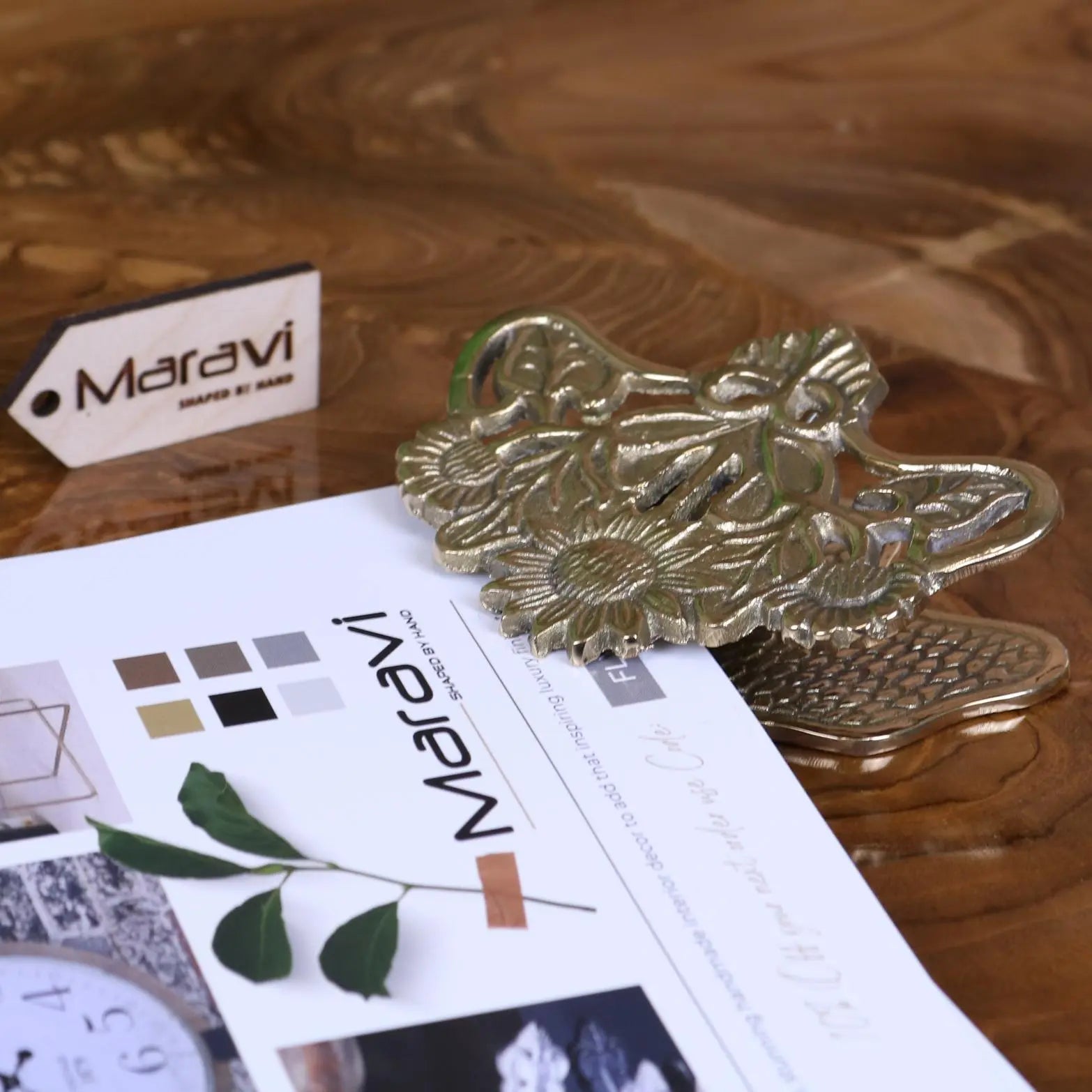 Gold-toned ornate metal paper clip shaped like a sunflower with detailed leaves perfect for luxury desk accessories