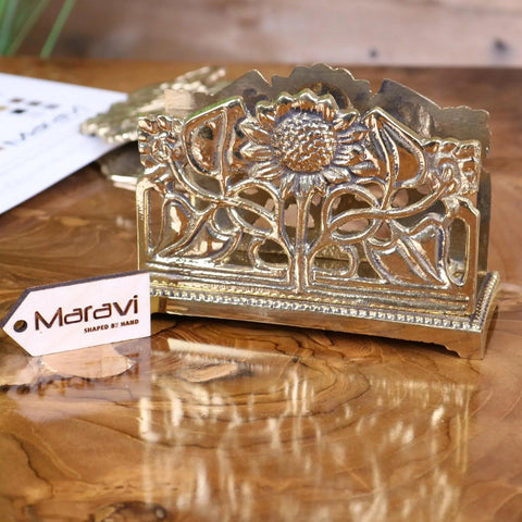 Handcrafted gold-toned metal napkin holder with intricate sunflower design perfect for luxury desk accessories