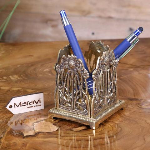 Silver ornate metal pen holder with floral vine design holding two blue pens perfect luxury desk accessories