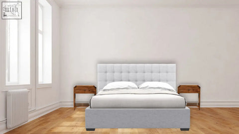 A tufted white upholstered bed with gray base and chestnut mango wood newton bedside tables on each side