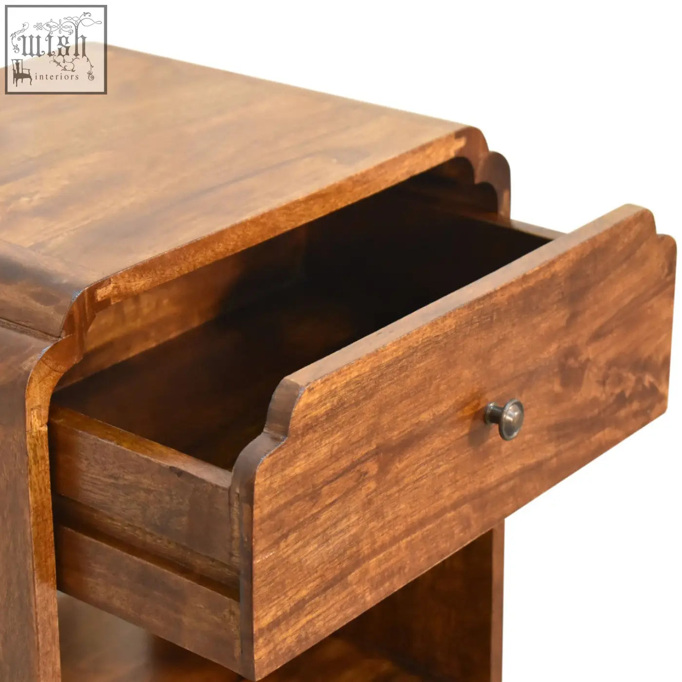 Warm brown newton bedside table made of chestnut mango wood with curved drawer front and small round metal knob