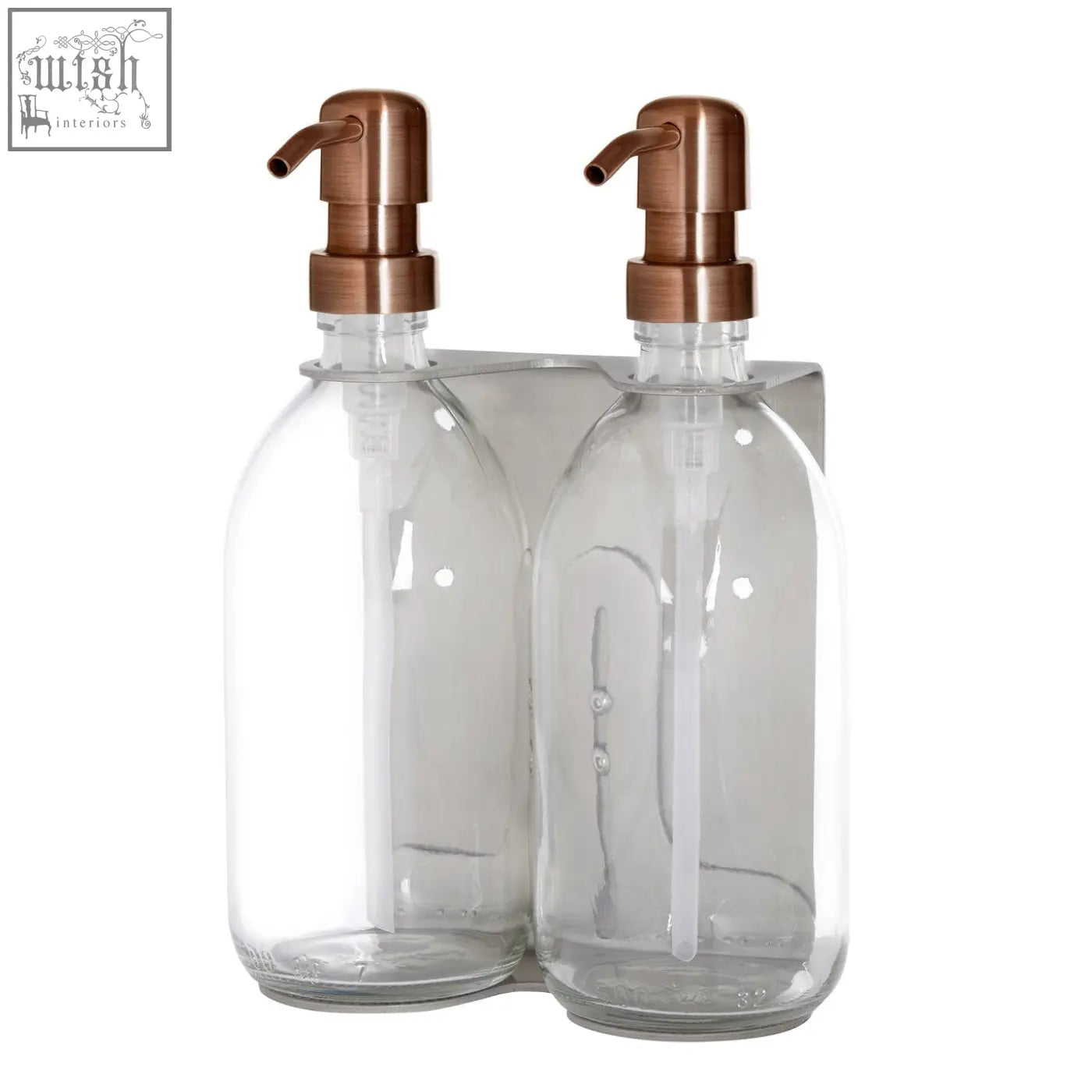 Nickel double wall mounted soap dispenser with clear glass bottles and rose gold pumps on a stainless steel base