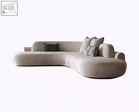 Beige velvet nicosia grey curved three seater sofa with modern design and assorted throw pillows