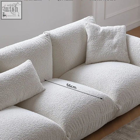 Cream-colored nimbus sofa with plush faux-fur upholstery and matching pillows featuring luxurious fabric and contemporary lines