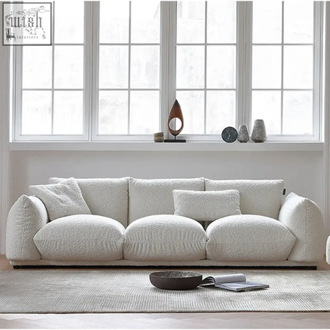Cream-colored nimbus sofa with plush sheepskin texture luxurious fabric rounded armrests and matching cushions
