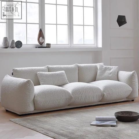 Cream-colored nimbus sofa with plush faux-fur luxurious fabric and contemporary lines for modern living spaces