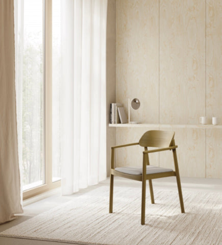 Minimalist nimma chair with light gold wooden frame and upholstered seat perfect for modern interiors