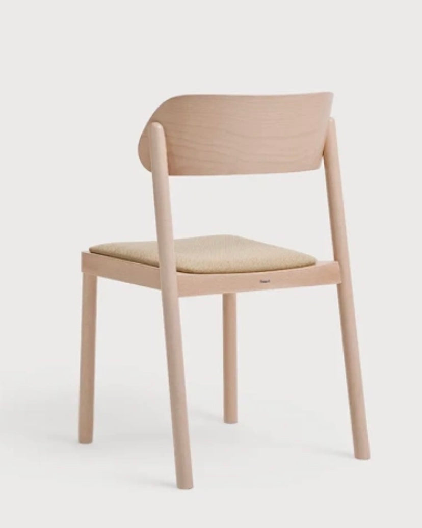 Minimalist wooden nimma chair with light natural finish and beige upholstered seat for stylish seating