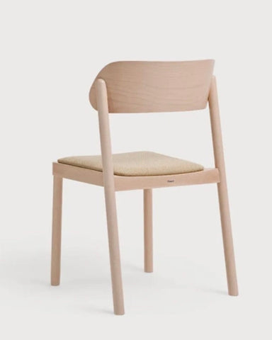 Minimalist wooden nimma chair with light natural finish and beige upholstered seat for stylish seating