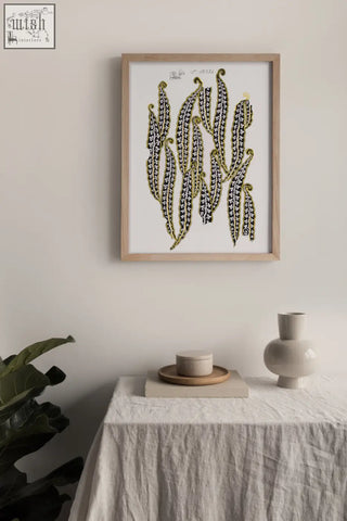 A framed vintage archive poster print showing stylized black and yellow magic beans on a white background