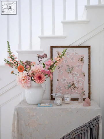 A white ceramic vase with a lush pink peach and orange flower arrangement for spring romance prints