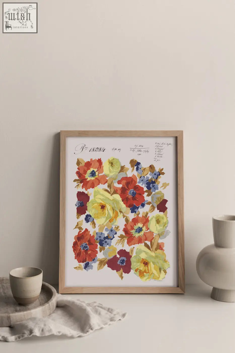 A framed floral artwork of autumnal blooms in red yellow and blue printed on sustainable bamboo paper