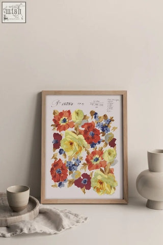 A framed floral artwork of autumnal blooms in red yellow and blue printed on sustainable bamboo paper