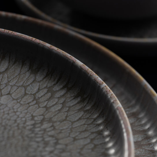 Dark gray ceramic nocturne coupe plate 7 inch with textured crackled glaze and subtle brownish rim
