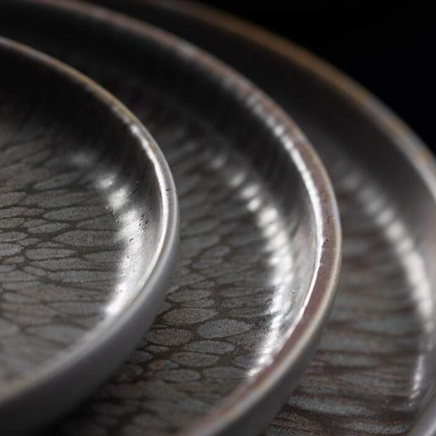 Set of three nocturne coupe plates in dark gray ceramic with crackled glaze and subtle metallic rims 7 inches