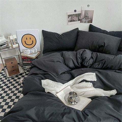Black duvet bedding set with soft slightly wrinkled texture and matching pillows perfect for cozy black bedding