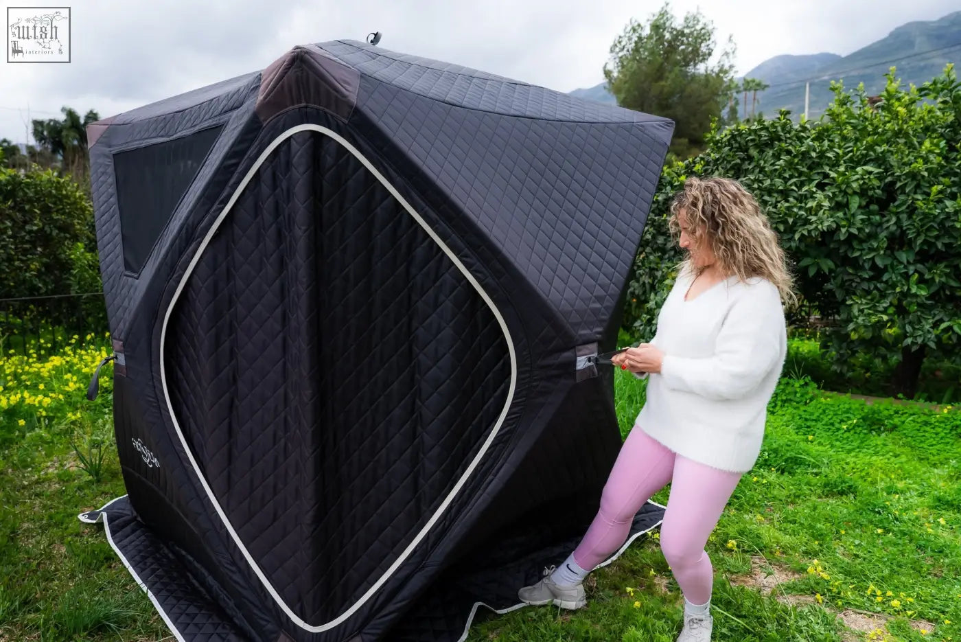 Black quilted fabric tent with white trim and diamond entrance as second tent in finsteam r14s safety pack sauna suite
