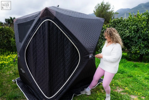 Black quilted fabric tent with white trim and diamond entrance as second tent in finsteam r14s safety pack sauna suite