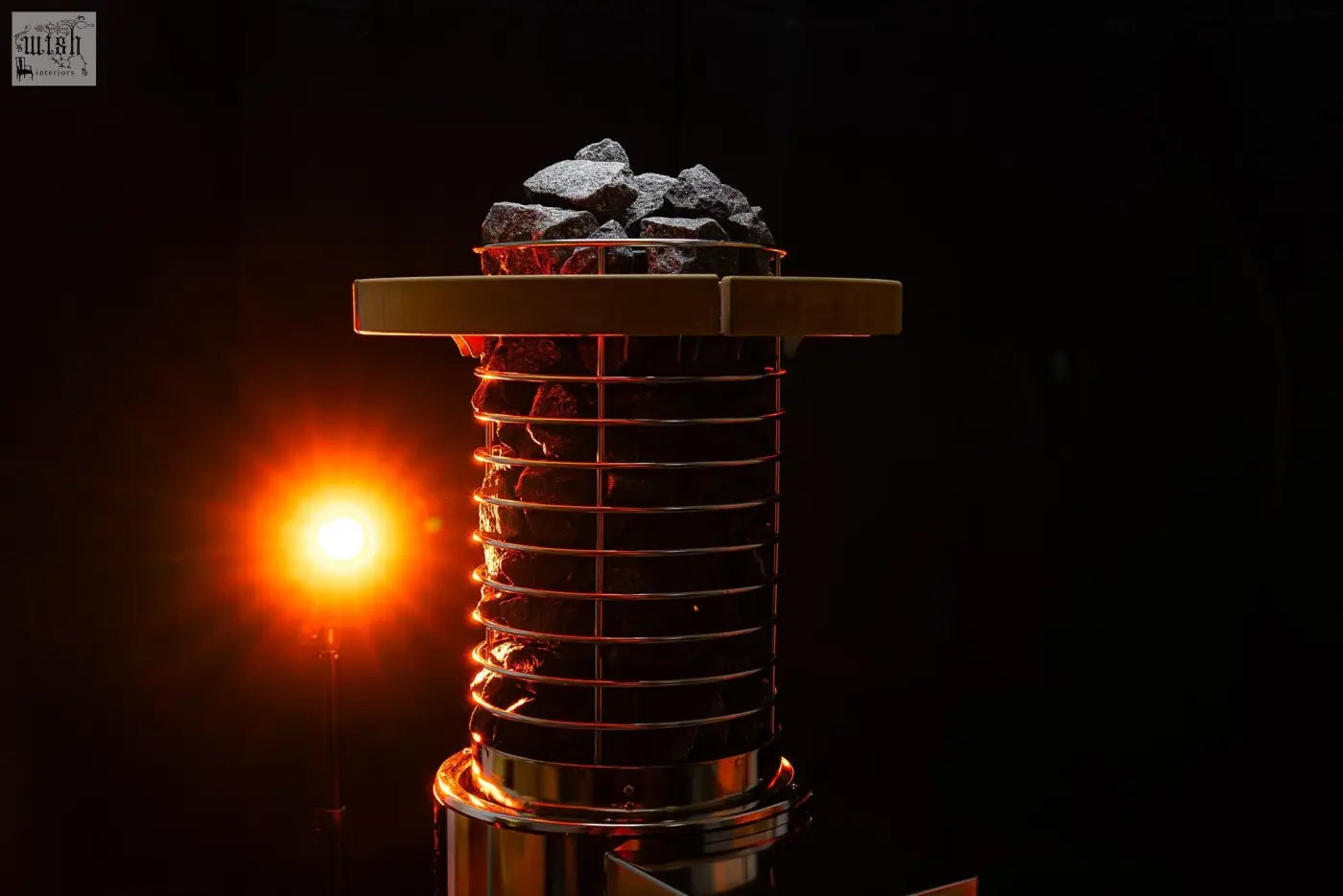 A sleek metallic r14s electric heater with stacked coil design and charcoal briquettes for noir xxl second tent safety pack