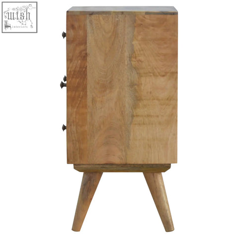 A light brown solid mango wood bedside table with three drawers and tapered legs in nordic style