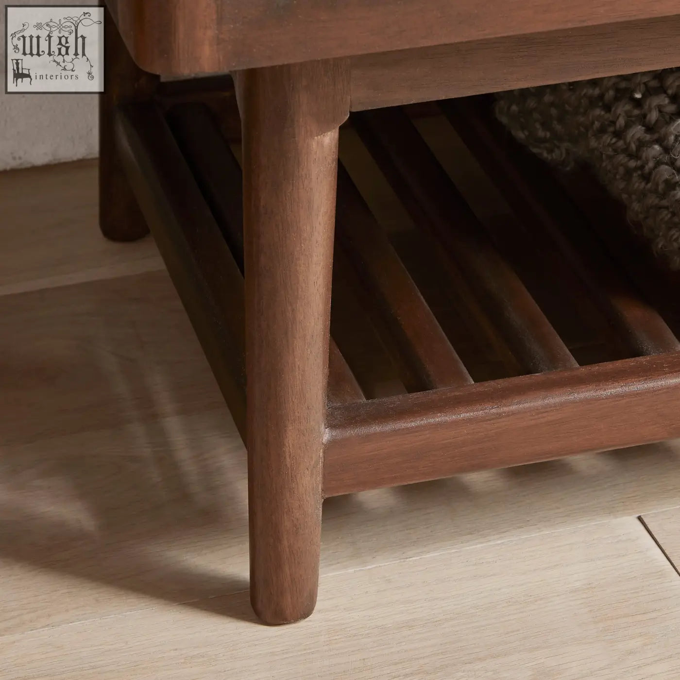 Dark brown wooden coffee table with slatted lower shelf and rounded legs matching norway walnut wardrobe style