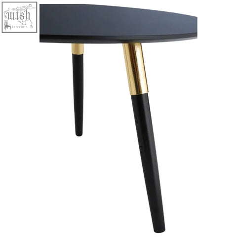 Black nostra coffee table with gold-accented metal legs perfect for stylish living room setups