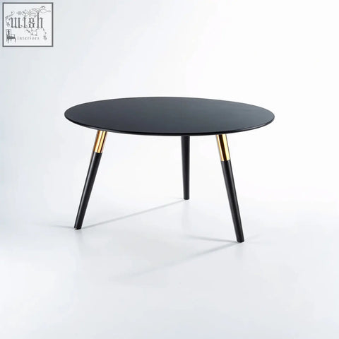 Black oval nostra coffee table with sleek tapered legs and gold bands for a stylish modern coffee table look